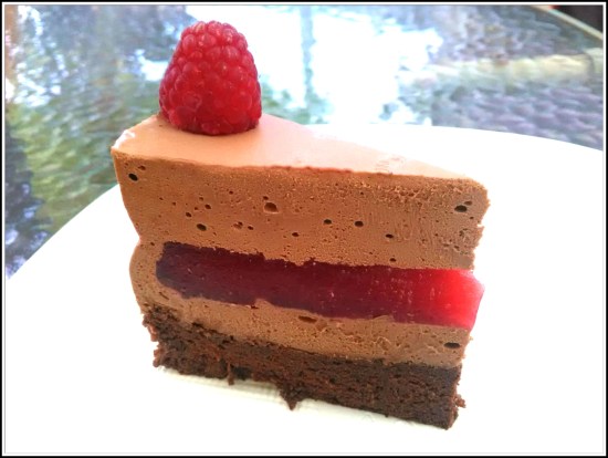 Trozo de tarta con mousse de chocolate y frambuesas